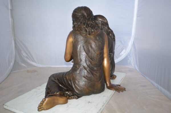 Two Girls Reading a Book Bronze Statue -  Size: 33"L x 21"W x 23"H.