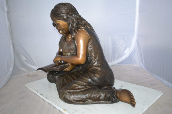 Two Girls Reading a Book Bronze Statue -  Size: 33"L x 21"W x 23"H.