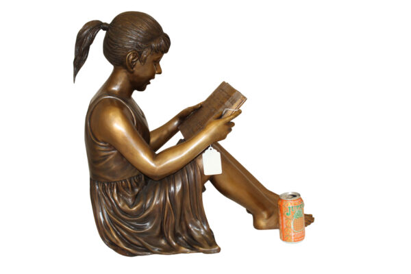 Girl Sitting and Reading a Book Bronze Statue -  Size: 23"L x 15"W x 24"H.