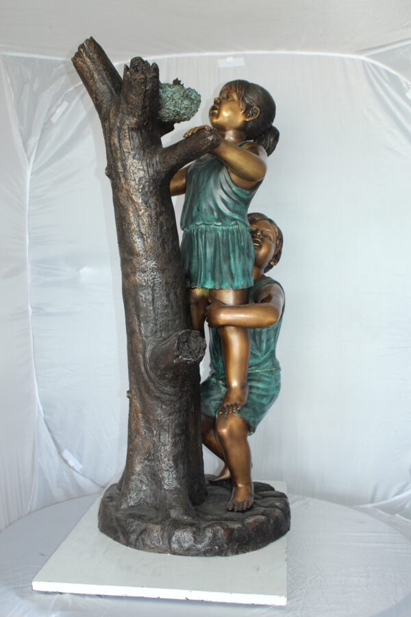 Two Kids Climbing on a Tree Bronze Statue -  Size: 17"L x 17"W x 46"H.