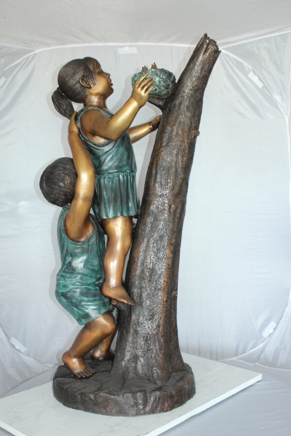 Two Kids Climbing on a Tree Bronze Statue -  Size: 17"L x 17"W x 46"H.