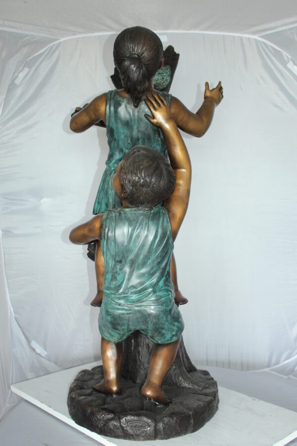 Two Kids Climbing on a Tree Bronze Statue -  Size: 17"L x 17"W x 46"H.