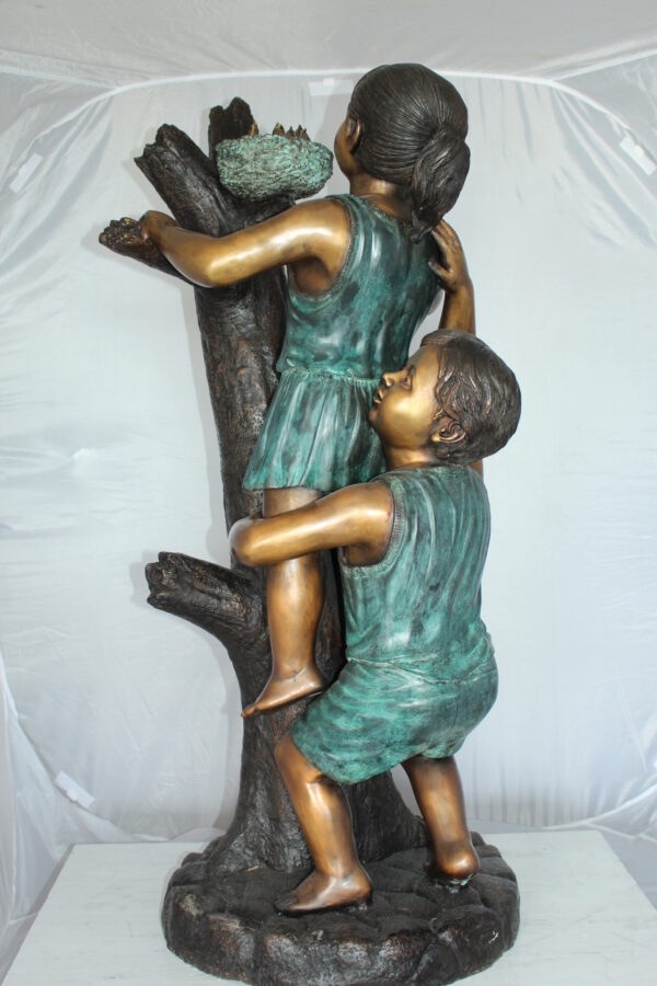 Two Kids Climbing on a Tree Bronze Statue -  Size: 17"L x 17"W x 46"H.