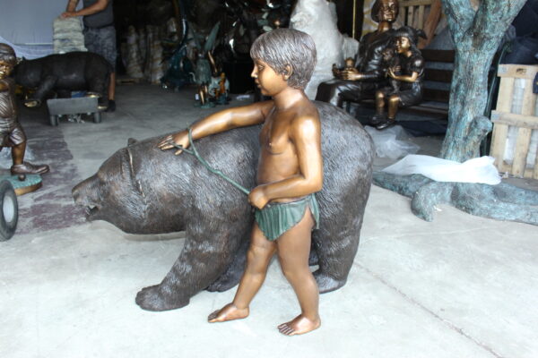 A bear with a boy bronze statue -  Size: 39"L x 24"W x 32"H. - Image 7