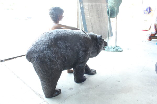 A bear with a boy bronze statue -  Size: 39"L x 24"W x 32"H. - Image 9