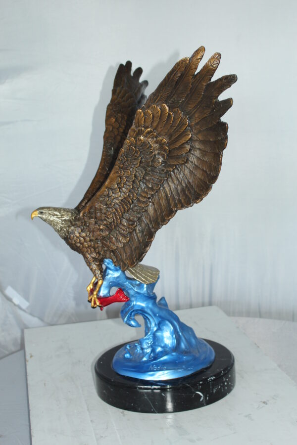 Eagle Catching his Prey Bronze Statue -  Size: 17"L x 20"W x 25"H.