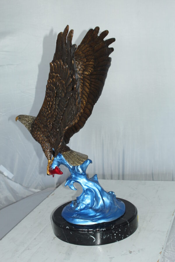 Eagle Catching his Prey Bronze Statue -  Size: 17"L x 20"W x 25"H.