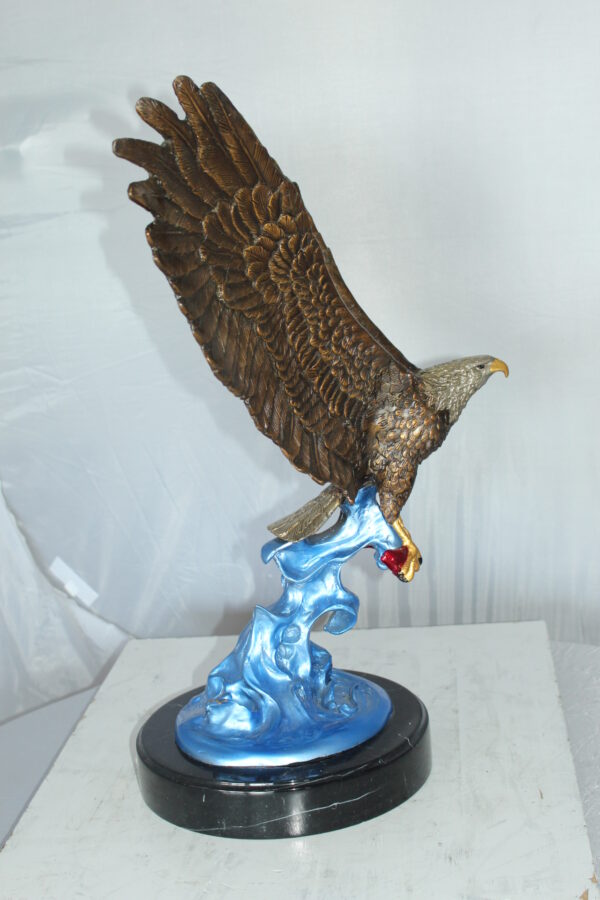 Eagle Catching his Prey Bronze Statue -  Size: 17"L x 20"W x 25"H.