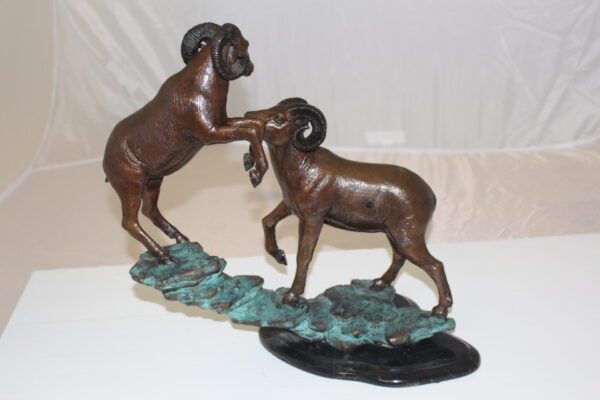 Two Rams on a rock Bronze Statue -  Size: 15"L x 8"W x 16"H.