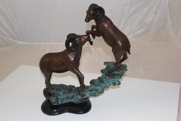 Two Rams on a rock Bronze Statue -  Size: 15"L x 8"W x 16"H.