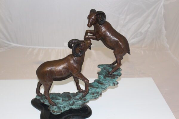 Two Rams on a rock Bronze Statue -  Size: 15"L x 8"W x 16"H.