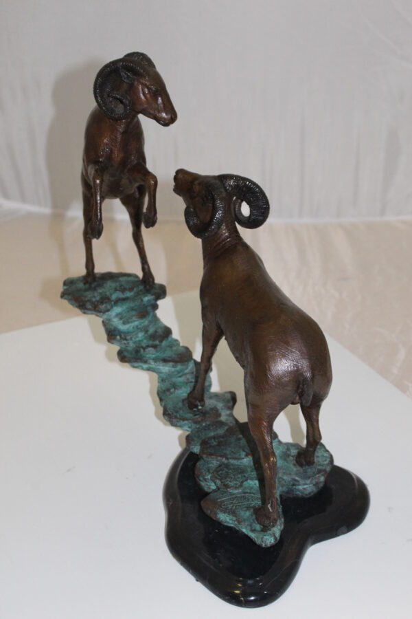 Two Rams on a rock Bronze Statue -  Size: 15"L x 8"W x 16"H.