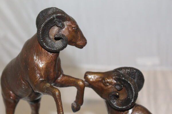 Two Rams on a rock Bronze Statue -  Size: 15"L x 8"W x 16"H.