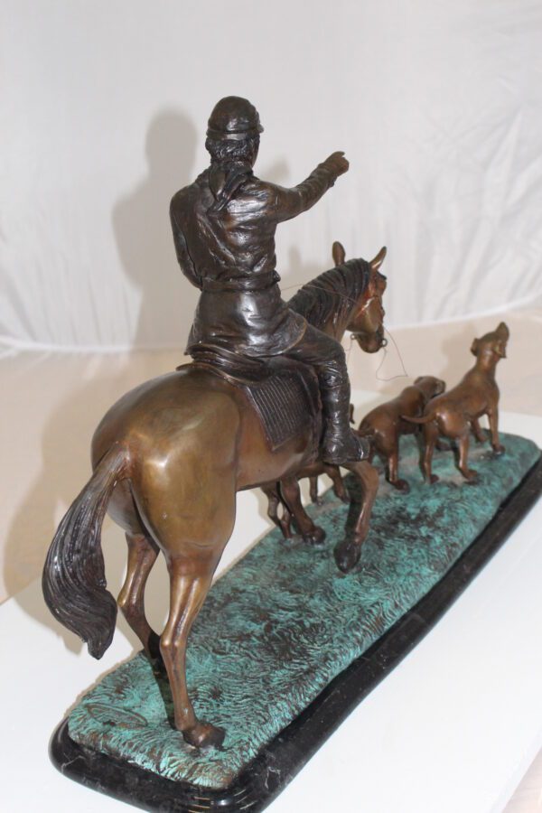 Hunter with 3 dogs Bronze Statue -  Size: 26"L x 8"W x 19"H.