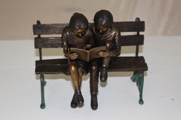 Two kids on bench reading a book - Bronze Statue -  Size: 9"L x 6"W x 8"H.