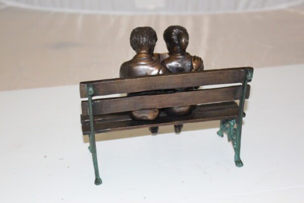 Two kids on bench reading a book - Bronze Statue -  Size: 9"L x 6"W x 8"H.