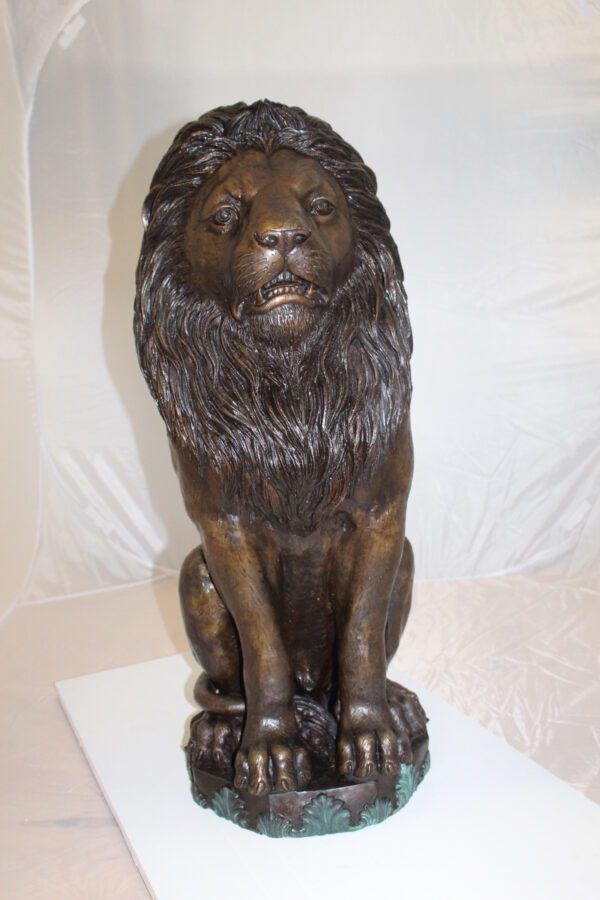 Lion Sitting on Base Bronze Statue -  Size: 13"L x 13"W x 34"H.