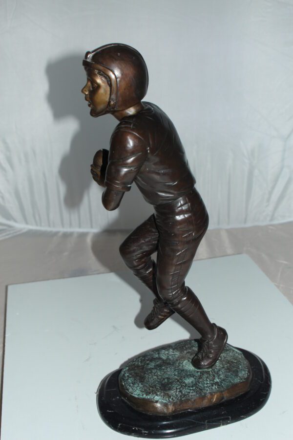 Boy playing football Bronze Statue -  Size: 10"L x 8"W x 20"H.