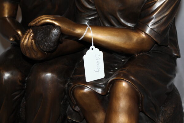 Two kids holding a bird Bronze Statue -  Size: 18"L x 26"W x 34"H.