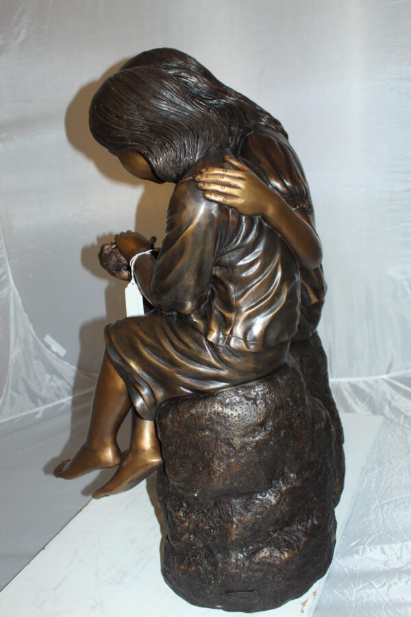 Two kids holding a bird Bronze Statue -  Size: 18"L x 26"W x 34"H.