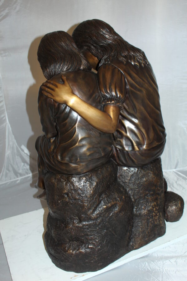 Two kids holding a bird Bronze Statue -  Size: 18"L x 26"W x 34"H.