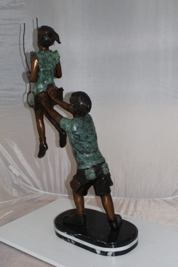 Children-on-swing-Bronze-Statue -  Size: 20"L x 9"W x 39"H.