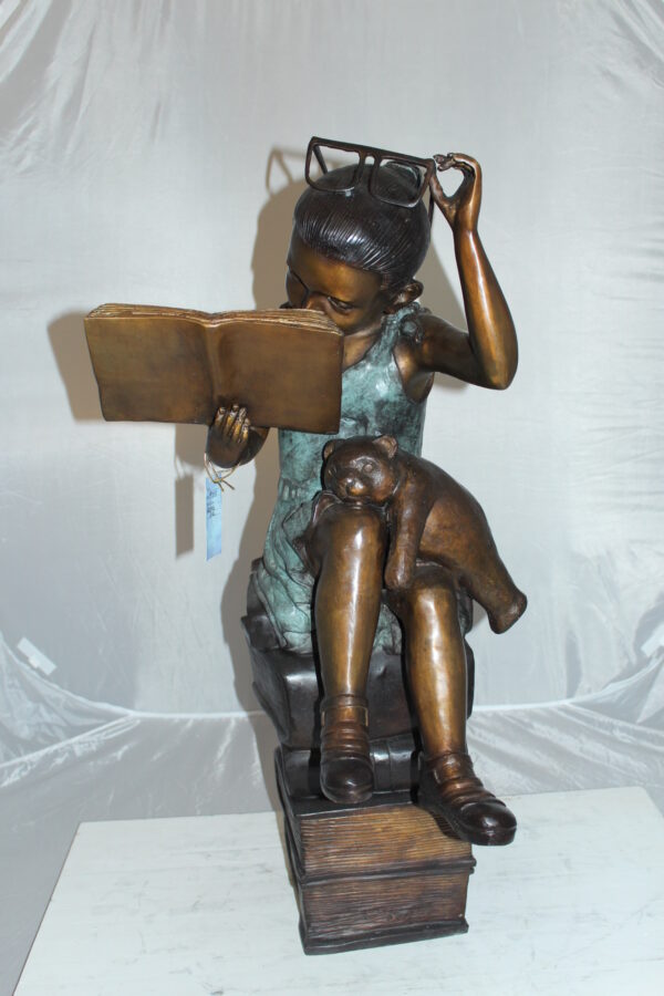 Girl sitting on a stack of books reading a book Bronze Statue -  17"x 18"x 36"H