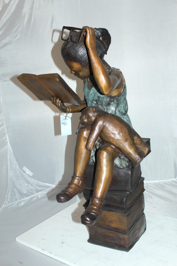 Girl sitting on a stack of books reading a book Bronze Statue -  17"x 18"x 36"H