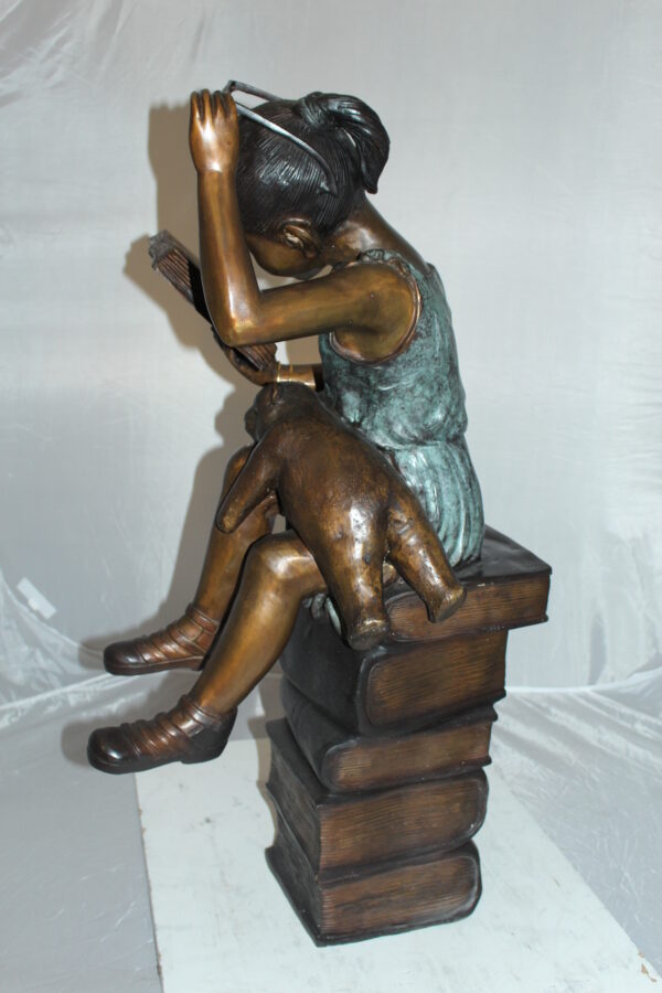 Girl sitting on a stack of books reading a book Bronze Statue -  17"x 18"x 36"H