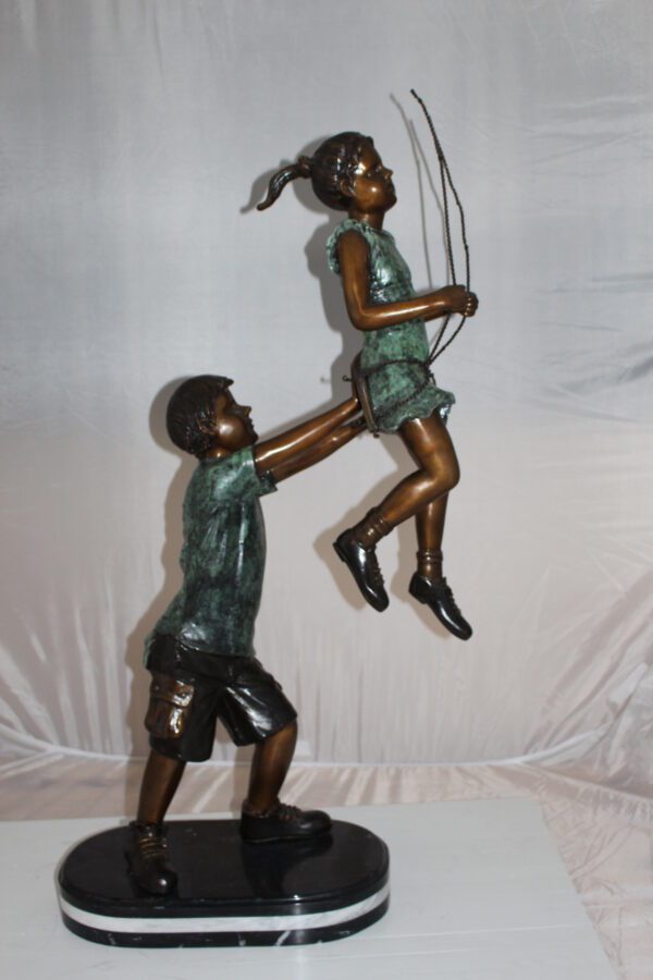 Children-on-swing-Bronze-Statue -  Size: 20"L x 9"W x 39"H.