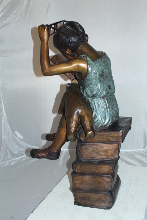 Girl sitting on a stack of books reading a book Bronze Statue -  17"x 18"x 36"H