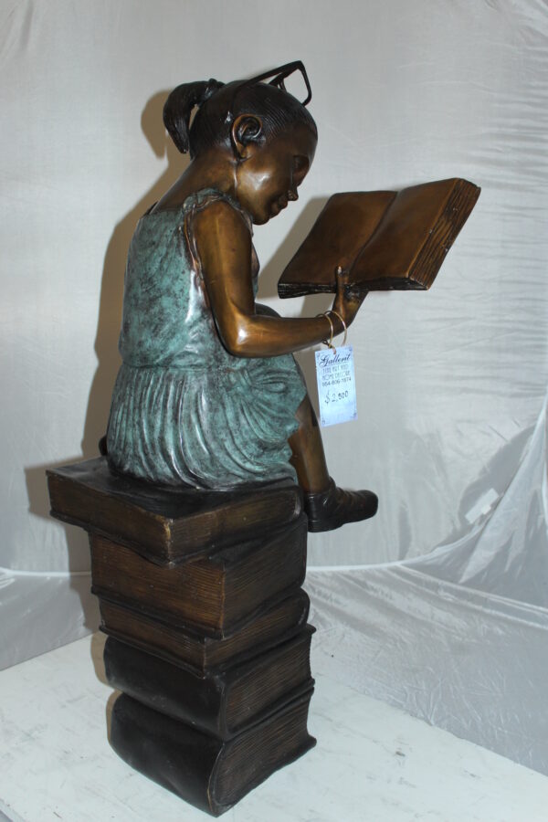 Girl sitting on a stack of books reading a book Bronze Statue -  17"x 18"x 36"H