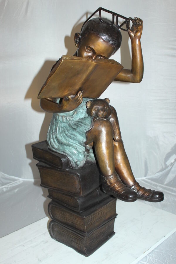 Girl sitting on a stack of books reading a book Bronze Statue -  17"x 18"x 36"H