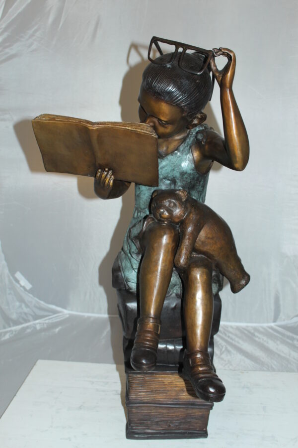 Girl sitting on a stack of books reading a book Bronze Statue -  17"x 18"x 36"H