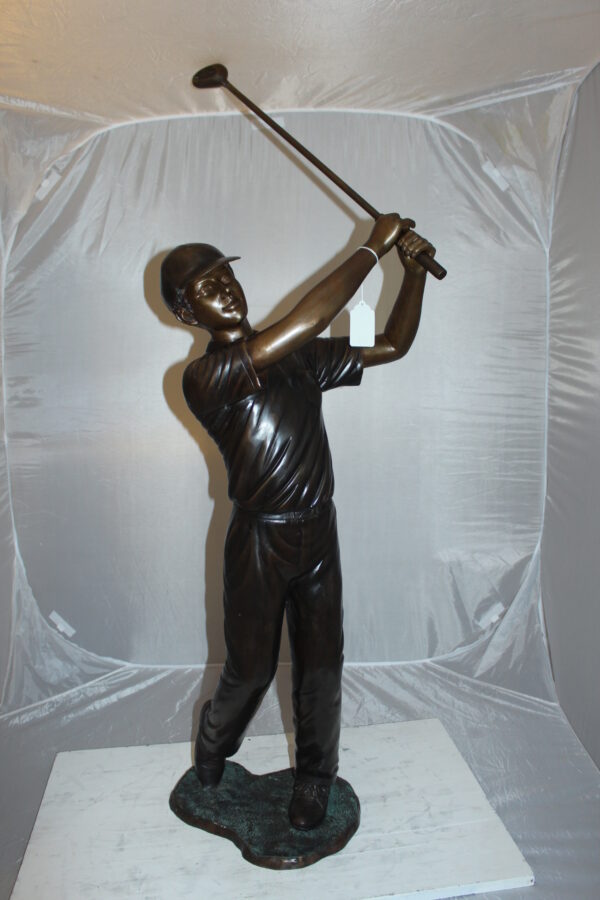 Teen boy plays golf Bronze Statue -  Size: 18"L x 13"W x 57"H.