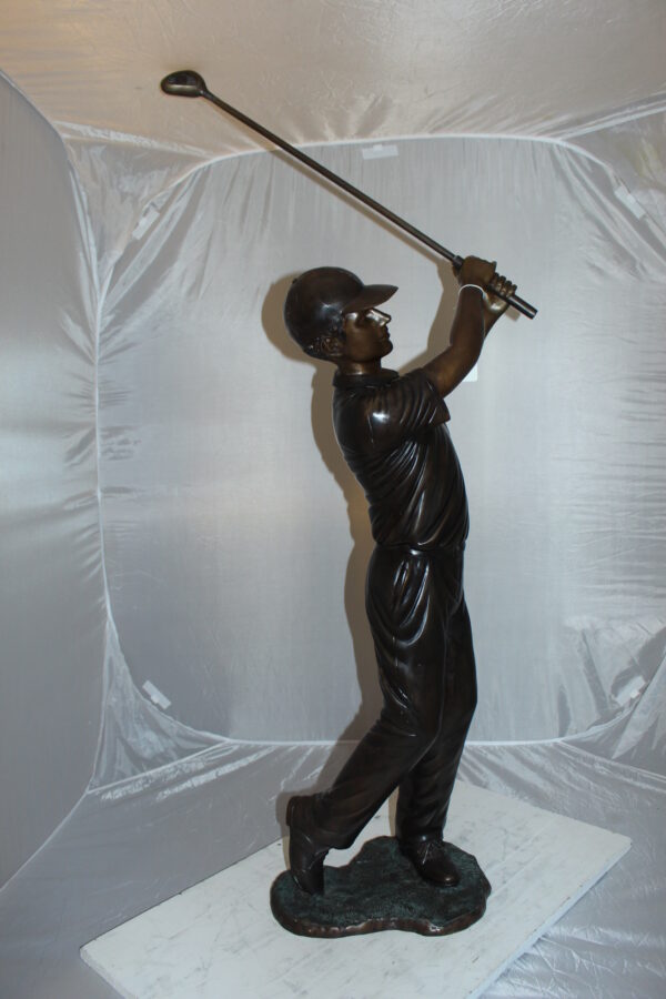 Teen boy plays golf Bronze Statue -  Size: 18"L x 13"W x 57"H.