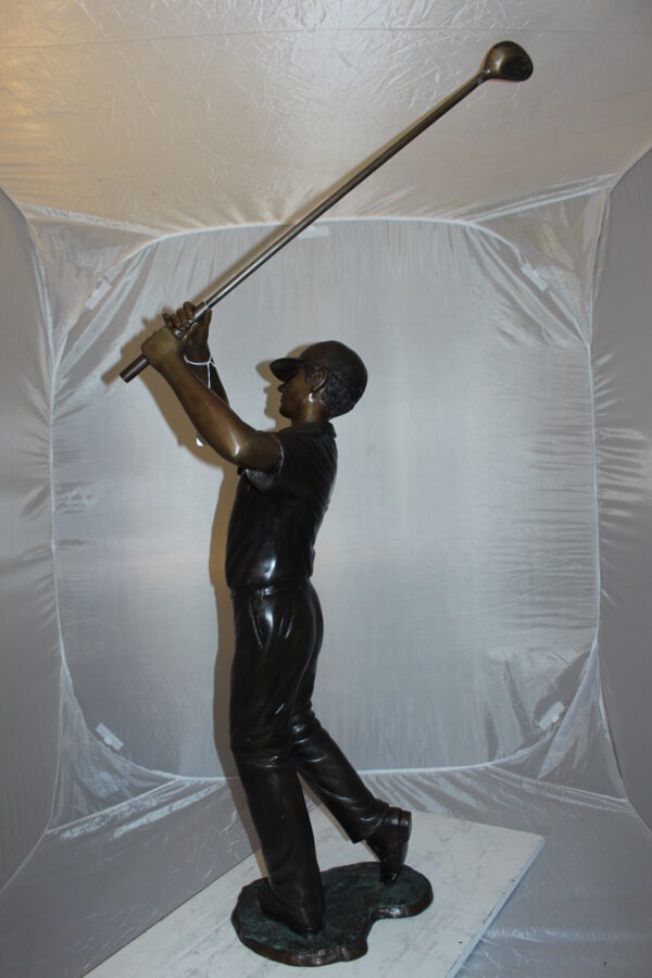 Teen boy plays golf Bronze Statue -  Size: 18"L x 13"W x 57"H.