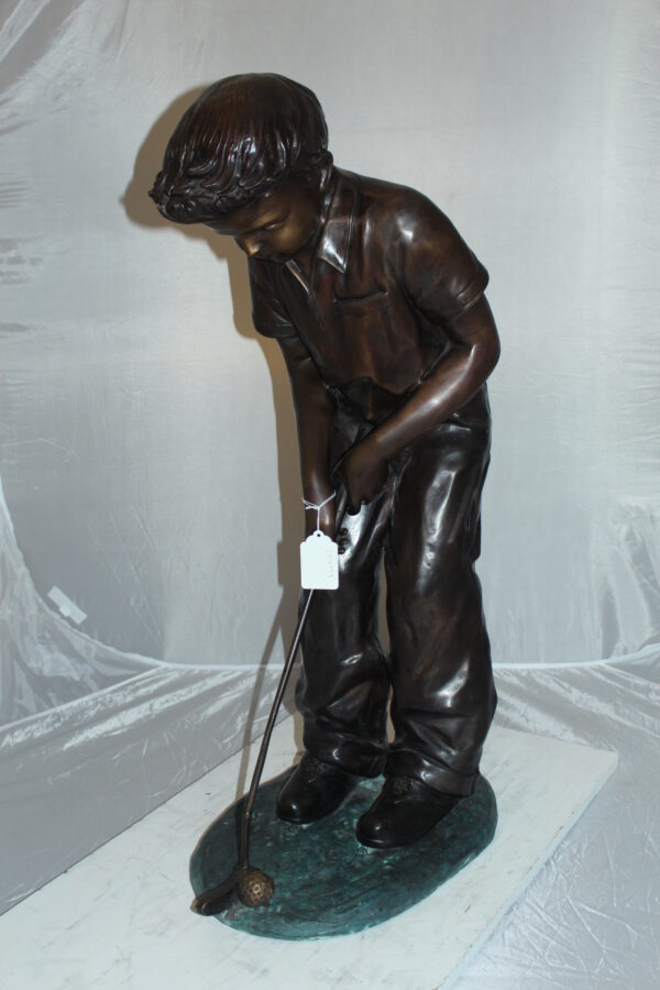 Boy plays golf Bronze Statue -  Size: 14"L x 18"W x 37"H.