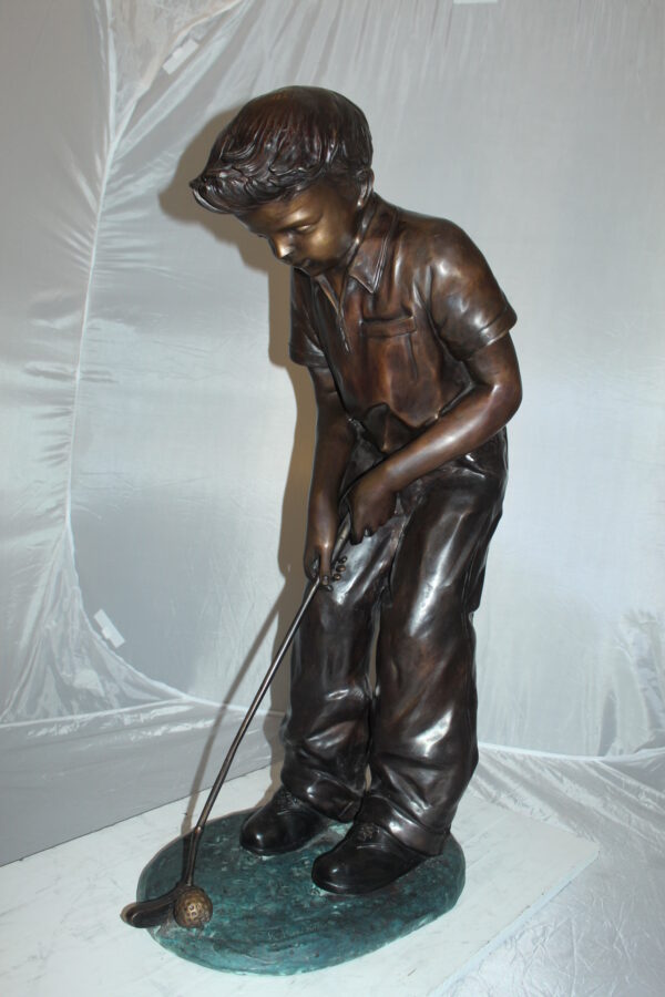 Boy plays golf Bronze Statue -  Size: 14"L x 18"W x 37"H.