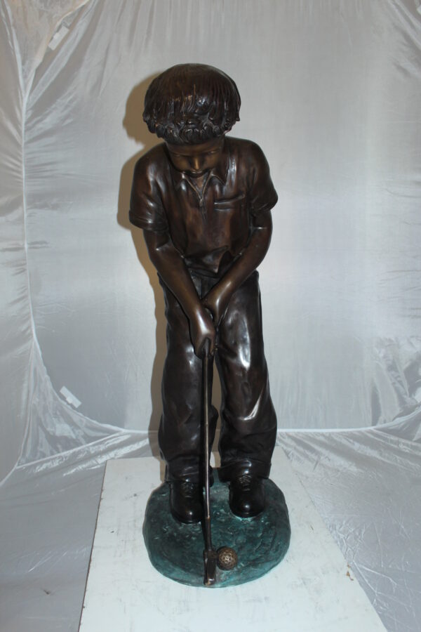 Boy plays golf Bronze Statue -  Size: 14"L x 18"W x 37"H.