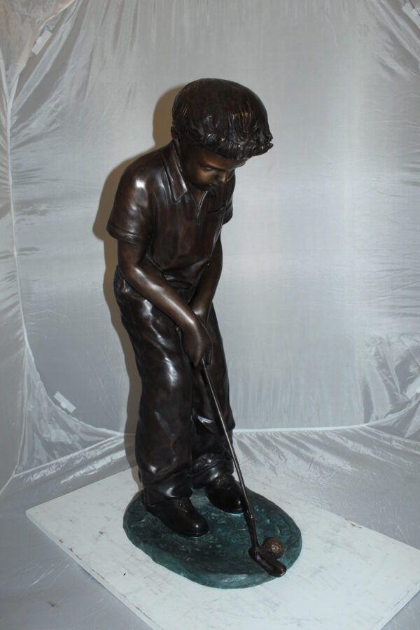 Boy plays golf Bronze Statue -  Size: 14"L x 18"W x 37"H.