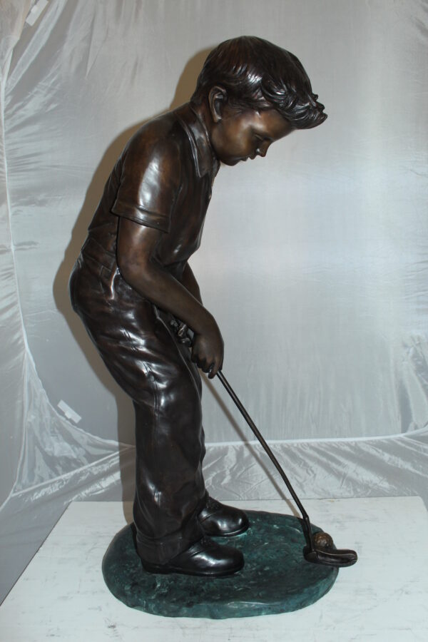 Boy plays golf Bronze Statue -  Size: 14"L x 18"W x 37"H.