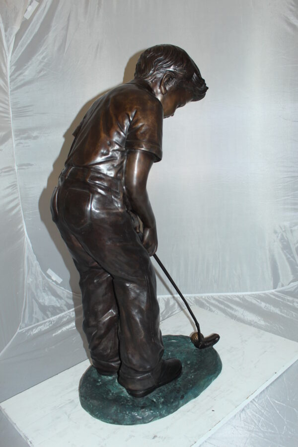 Boy plays golf Bronze Statue -  Size: 14"L x 18"W x 37"H.