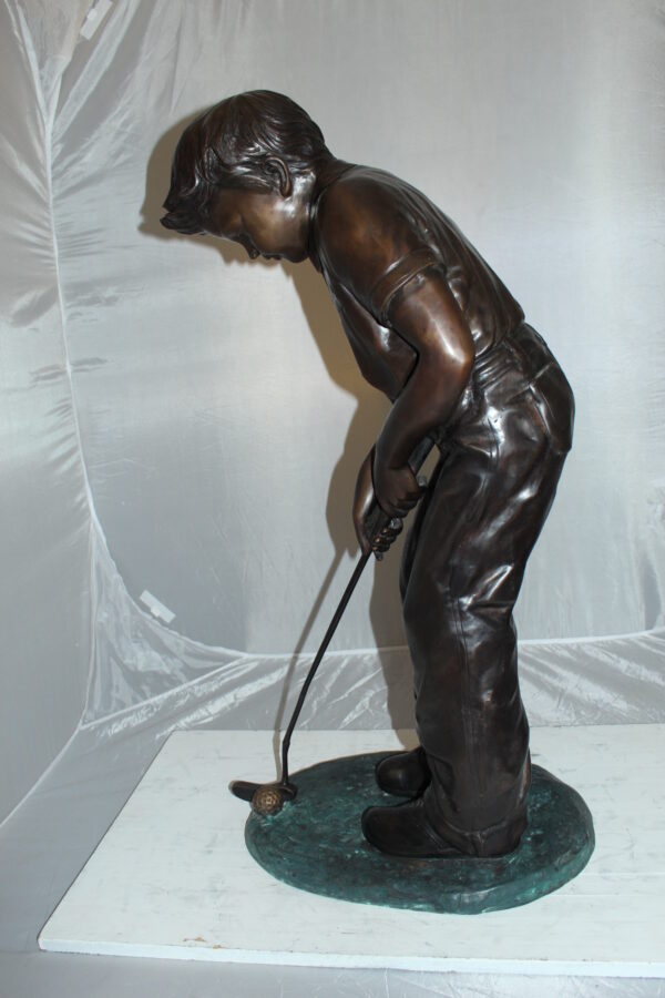 Boy plays golf Bronze Statue -  Size: 14"L x 18"W x 37"H.