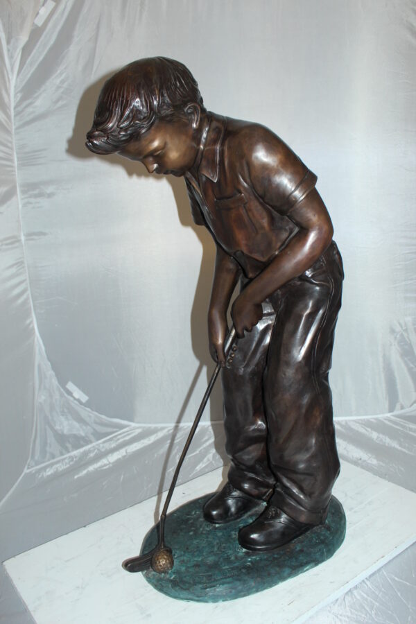 Boy plays golf Bronze Statue -  Size: 14"L x 18"W x 37"H.