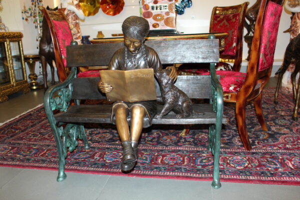 Girl sitting with her dog  on a bench,  reading Bronze Statue - 27" x 39" x 32"H