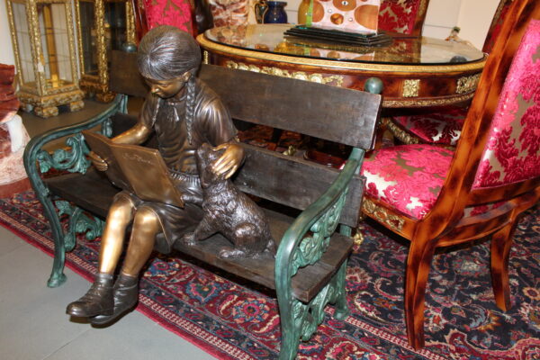 Girl sitting with her dog  on a bench,  reading Bronze Statue - 27" x 39" x 32"H