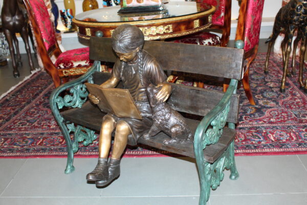 Girl sitting with her dog  on a bench,  reading Bronze Statue - 27" x 39" x 32"H