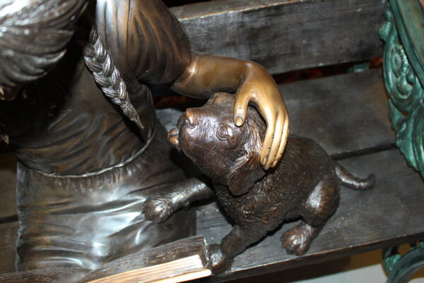 Girl sitting with her dog  on a bench,  reading Bronze Statue - 27" x 39" x 32"H