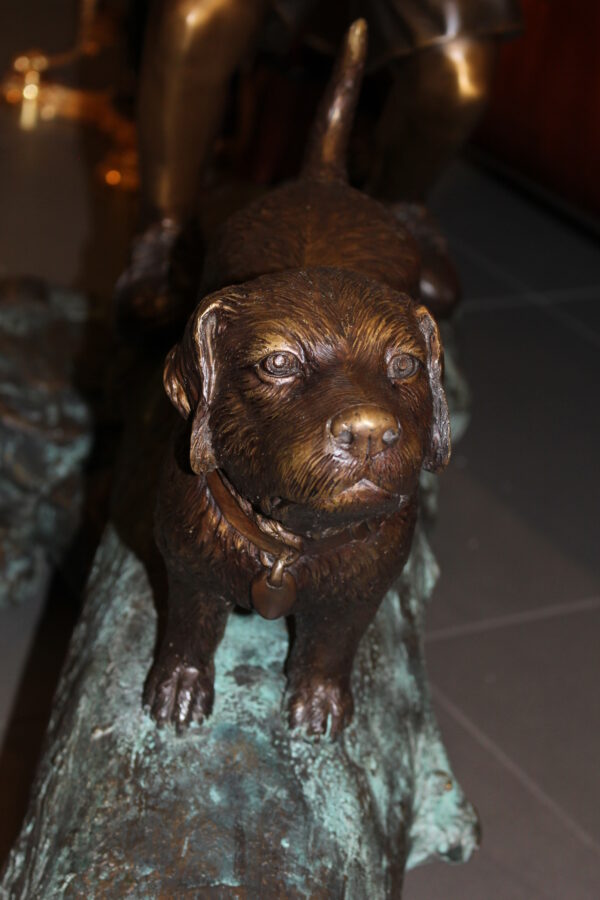 Kid with dog walking on a log Bronze Statue -  Size: 57"L x 18"W x 41"H.